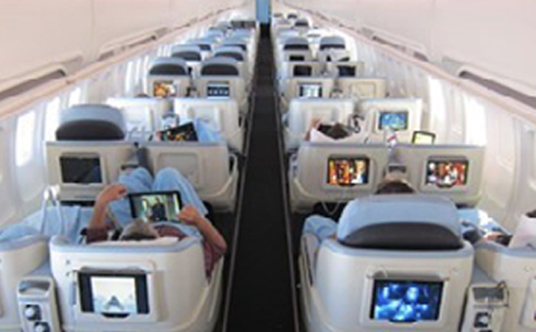 An image showing some tablets in an airplane being operated by passengers